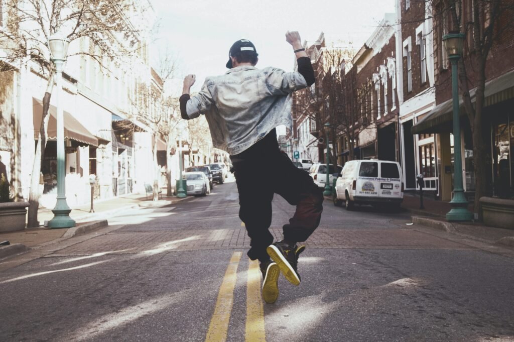 A person dances on a roadway - they are wearing black pants and a denim jacket. This is for an article about SEO